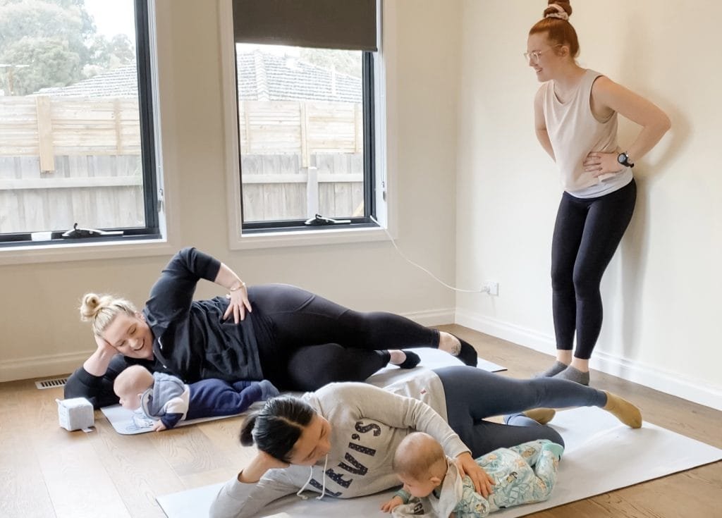 Postpartum physiotherapy - mother performing ehabilitation exercises with physiotherapist support